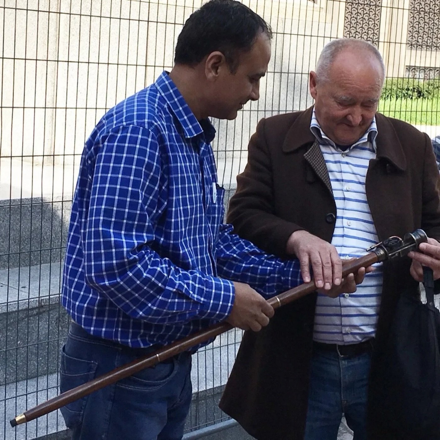 Mohammad Zafar showing a vintage telescope to a customer at the Carfar stand